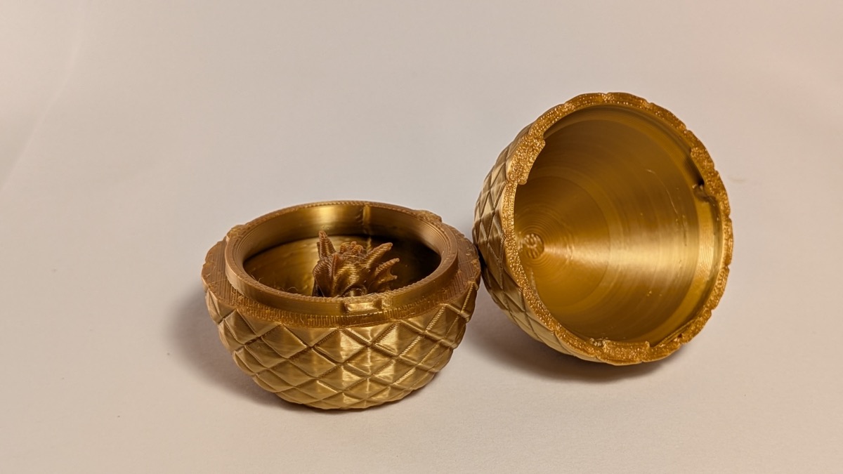 Gold dragon egg cracked open with baby dragon peeking out