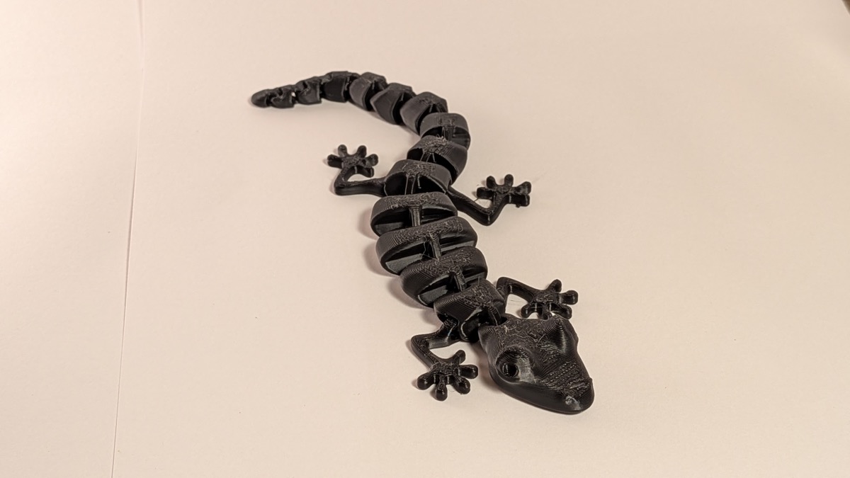 3D printed articulated lizard toy full body overhead view