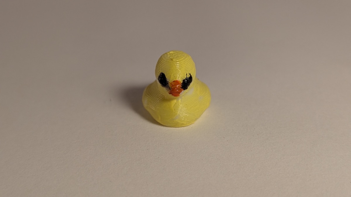 Tiny yellow 3D printed rubber duck toy