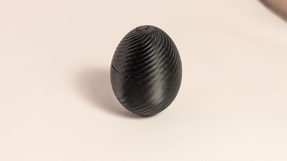 Black swirl-pattern 3D printed mystery egg